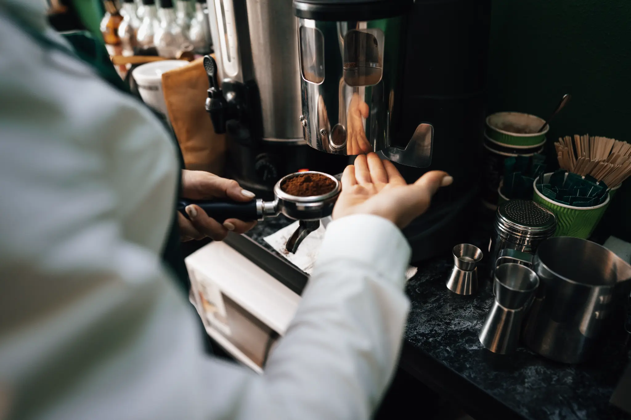 Professional barista hire - Close-up of expert hands preparing fresh espresso
